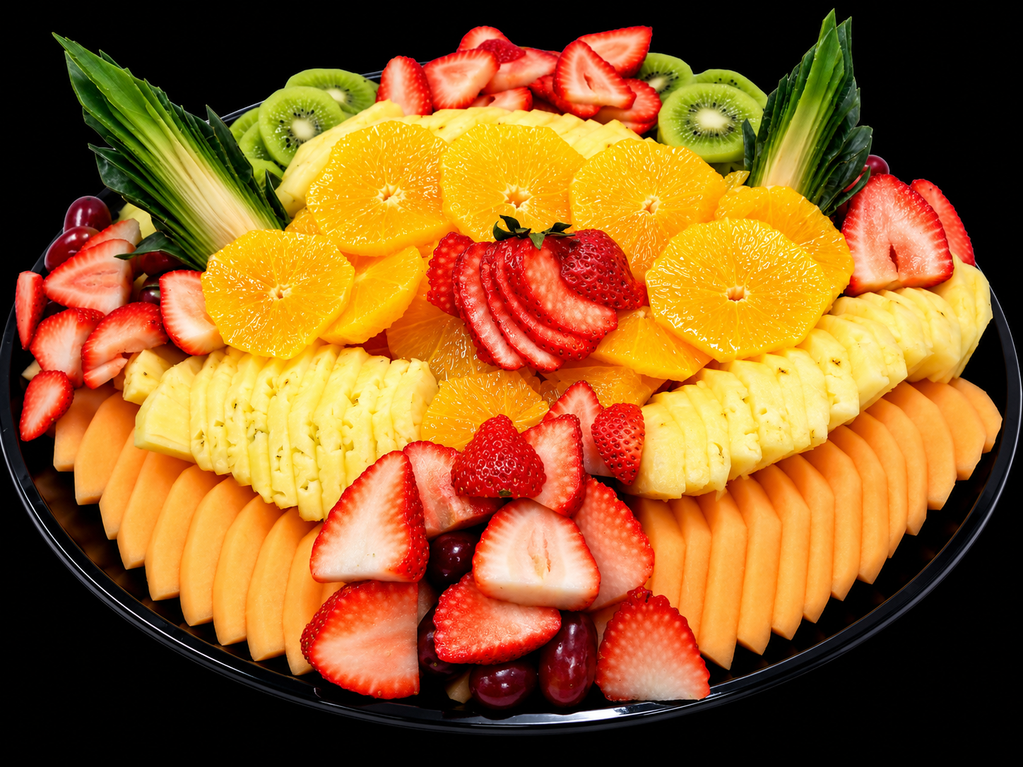 Vibrant tropical fruit platter with strawberries, pineapple, oranges, kiwi and melon