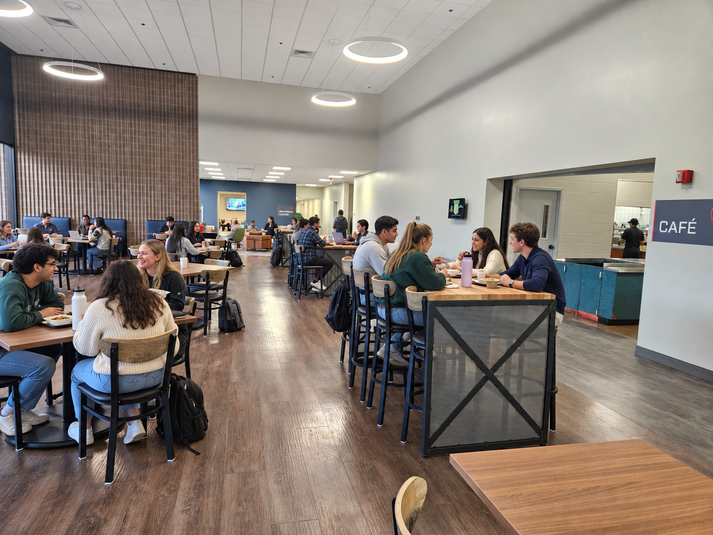Lively modern campus café lounge with CAFÉ sign